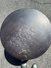 a person standing on top of a round table