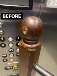 an elevator door handle with a wooden ball on it