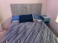 a bed in a room with a wooden headboard