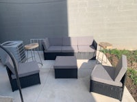 a wicker patio furniture set on a concrete patio