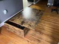 a coffee table with a storage compartment in it