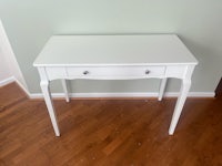 a white desk with drawers in a room