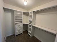 an empty closet with shelves and drawers