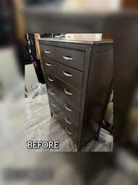 a chest of drawers with paint on it