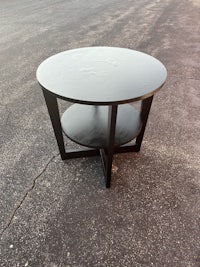 a black coffee table sitting in a parking lot